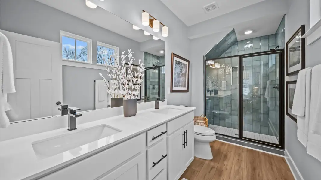 Superior en-suite primary bathroom with stylish dual vanity and tiled walk-in shower—crafted with high standards in mind Superior en-suite primary bathroom with stylish dual vanity and tiled walk-in shower—crafted with high standards in mind