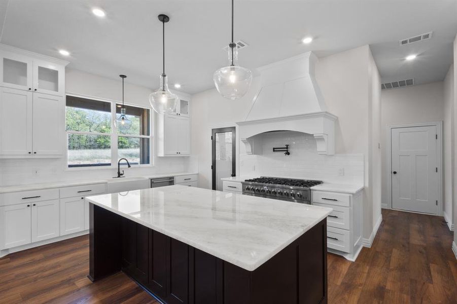 Kitchen featuring a sink, visible vents, range, and recessed lighting