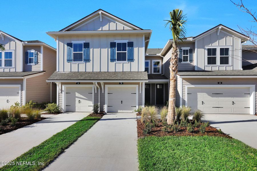 Front exterior of a new home in Woodland Park, Nocatee, FL, highlighting curb appeal (Image 2).