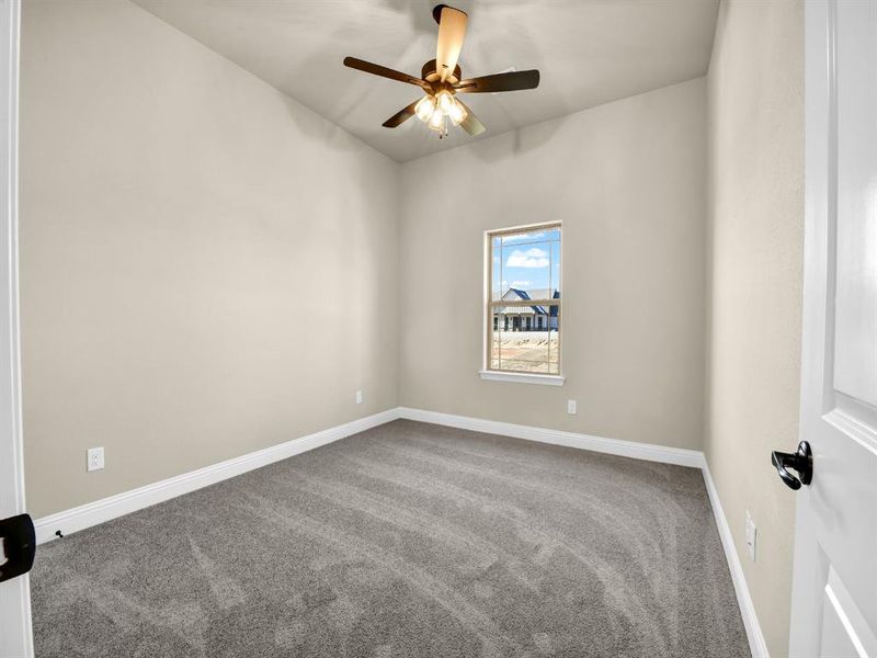 Unfurnished room featuring ceiling fan and carpet