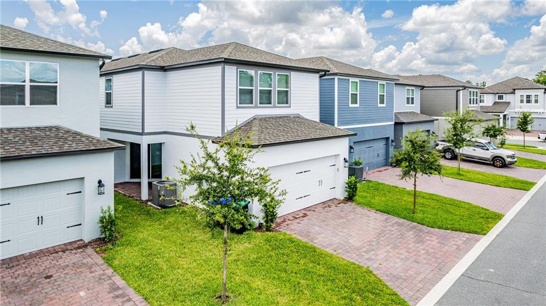 Front exterior of a new home in Encore at Ovation, Winter Garden, FL, highlighting curb appeal (Image 19).
