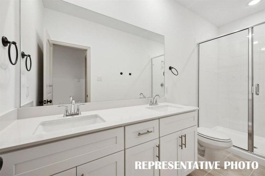 Ample room for two in this lovely owner's bath featuring dual vanity sinks and spacious walk in shower.  REPRESENTATIVE PHOTO