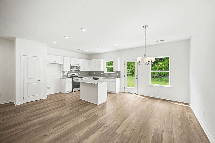 Kitchen with an island and separate dining space. Kitchen with an island and separate dining space.