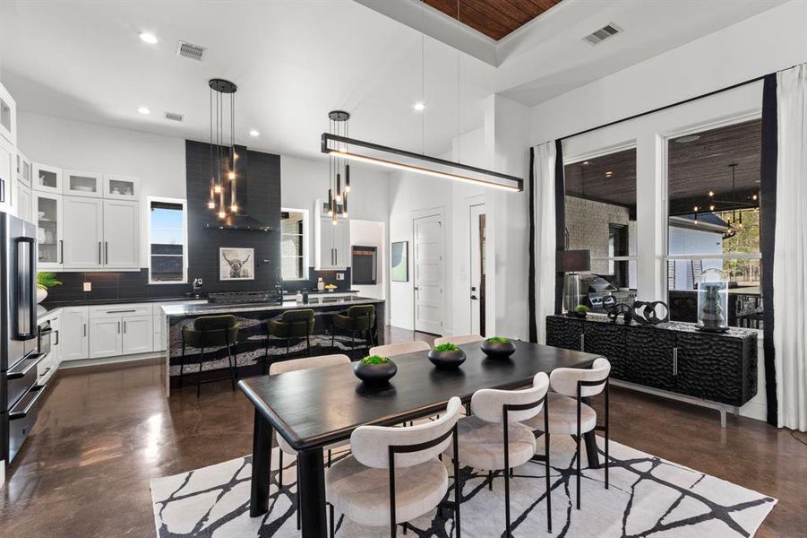 This dining space has separation from the other living areas, beautiful picture windows and modern finishes to accompany.