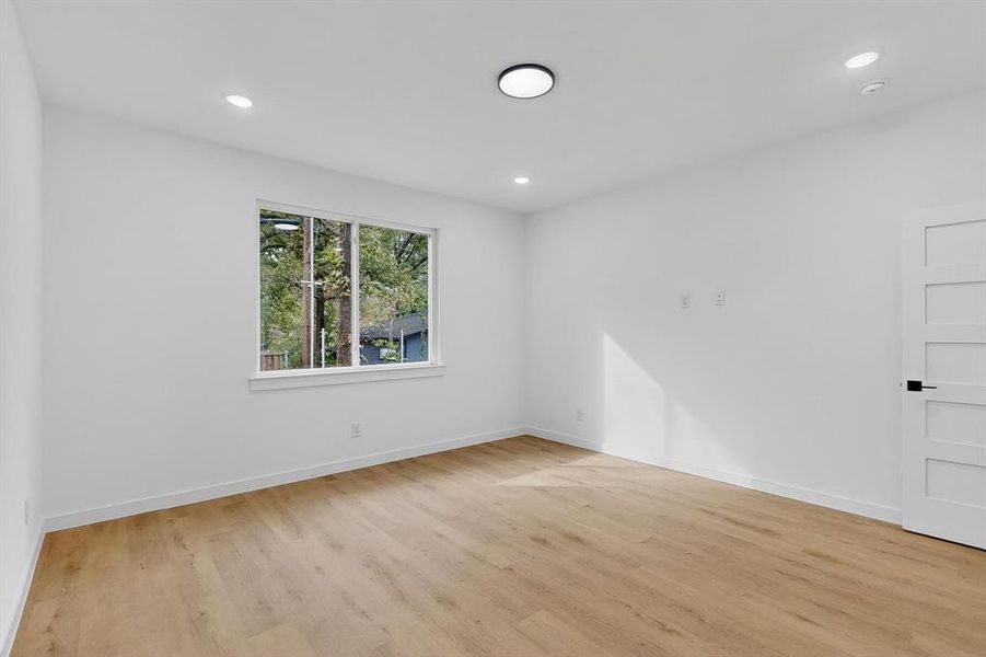 Spare room with light wood-type flooring and recessed lighting Spare room with light wood-type flooring and recessed lighting
