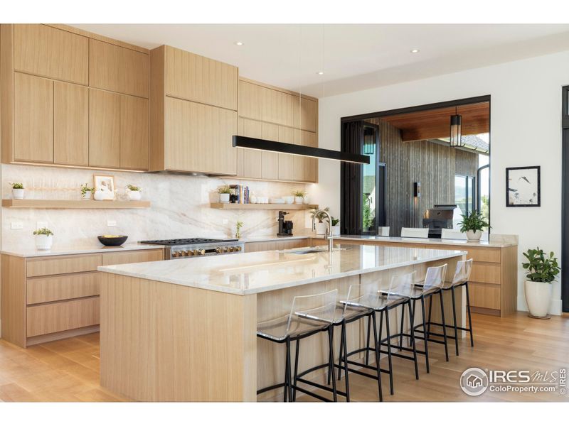 A sliding NanaWall opens to an outdoor breakfast bar, and glass doors extend dining to both east- and west-facing patios. A sliding NanaWall opens to an outdoor breakfast bar, and glass doors extend dining to both east- and west-facing patios.