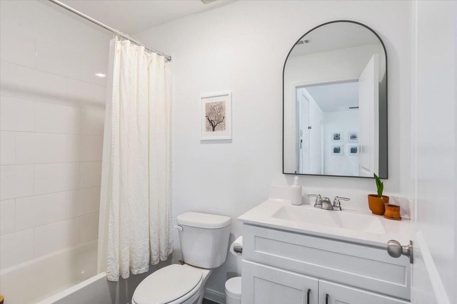 Third full bath with updated mirror is located upstairs.