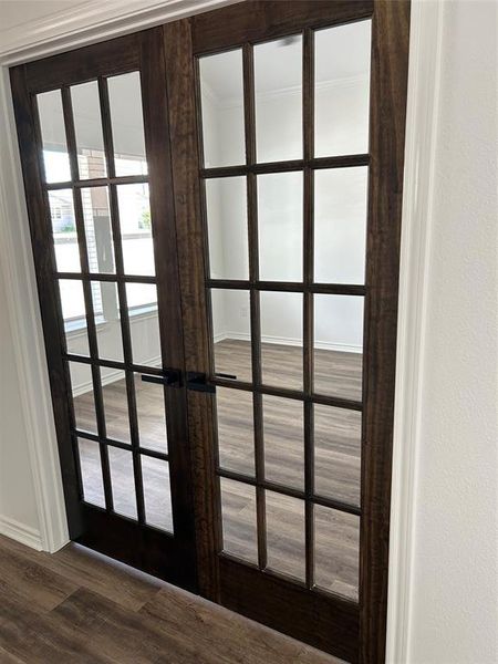 Detailed view of french doors and wood finished floors