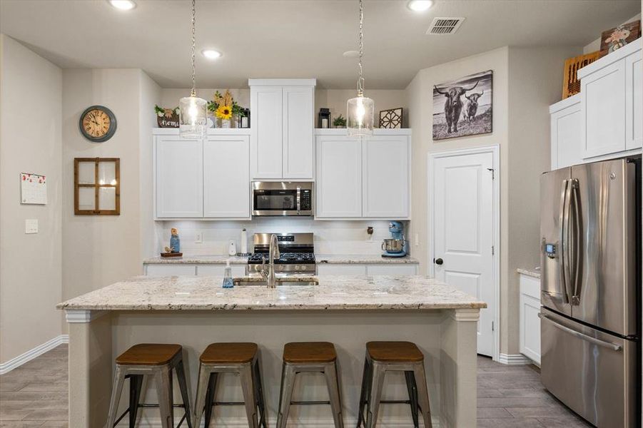 Island with sink and additional seating