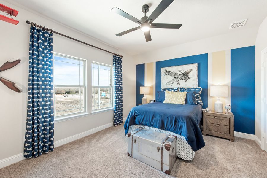 Children's bedroom with aviation theme, blue accent wall, ceiling fan, and carpet flooring Children's bedroom with aviation theme, blue accent wall, ceiling fan, and carpet flooring