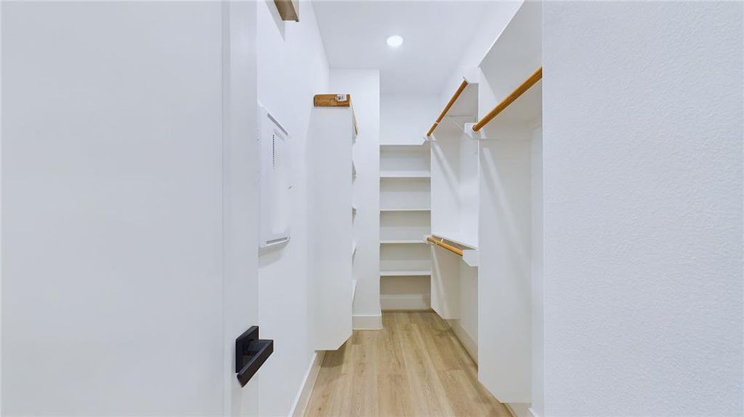 The closet provides ample double-hanging space, featuring two built-in shoe storage racks and additional long-hanging space for added convenience.