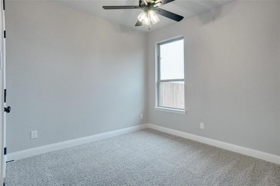 Empty room featuring carpet floors and ceiling fan