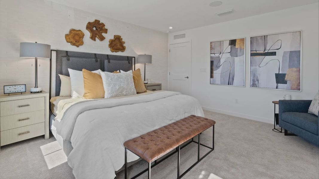 Spacious, carpeted primary suite in a DRB Home Clementine model at the Trinity Place community.