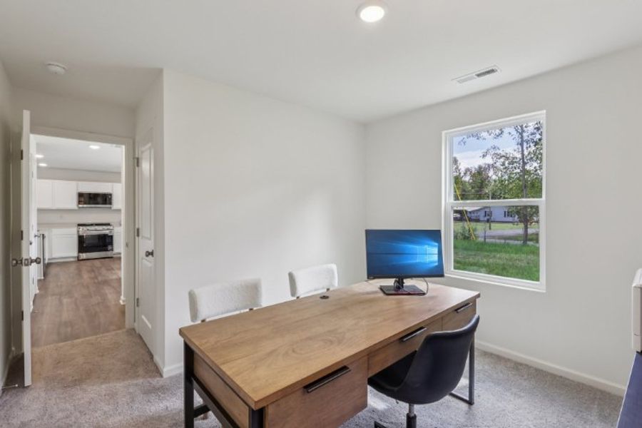 A room with a table and chairs.