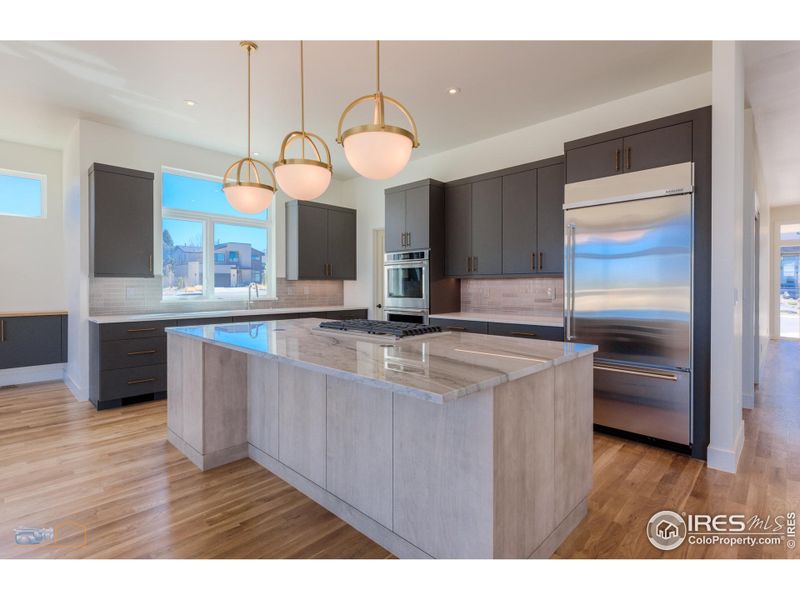 Gourmet Kitchen With Custom Cabinets, Quartz Countertops, Large Quartzite Island, SS Appliances, Walk-In Pantry & Undercabinet Lighting