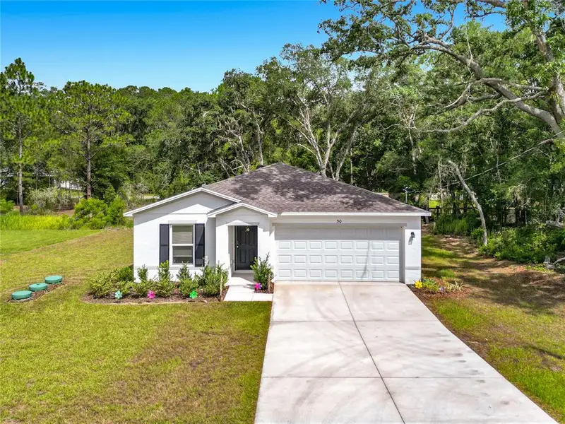 Front exterior of a new home in The Collection at Ocklawaha, Ocklawaha, FL, highlighting curb appeal (Image 23). Front exterior of a new home in The Collection at Ocklawaha, Ocklawaha, FL, highlighting curb appeal (Image 23).