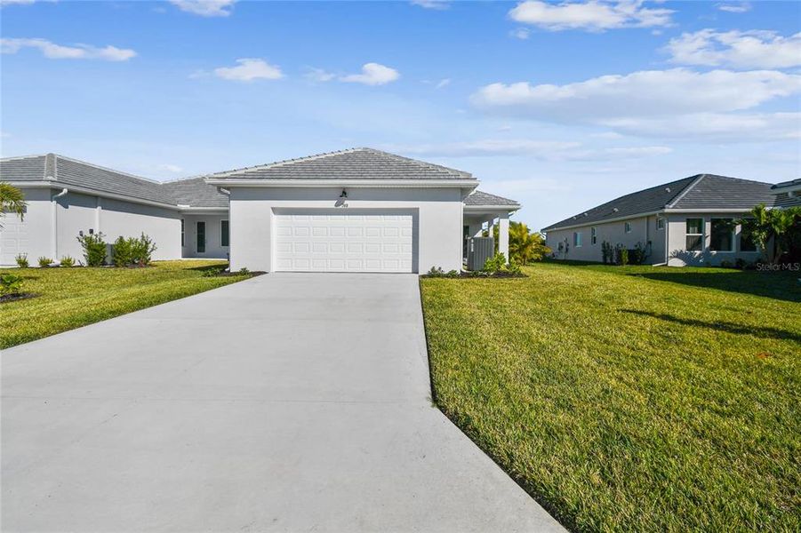 Front exterior of a new home in Vistera of Venice – Cottage Series, Nokomis, FL, highlighting curb appeal (Image 22).