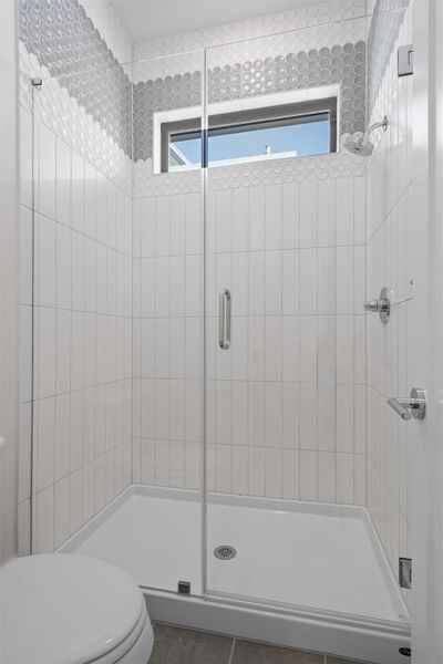 Full bath with a stall shower and plenty of natural light Full bath with a stall shower and plenty of natural light