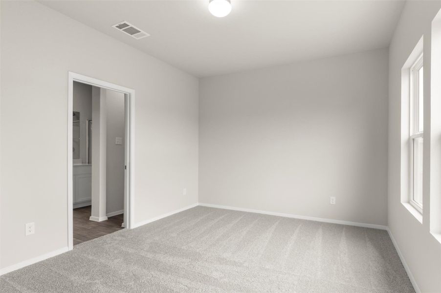 Carpeted empty room with baseboards