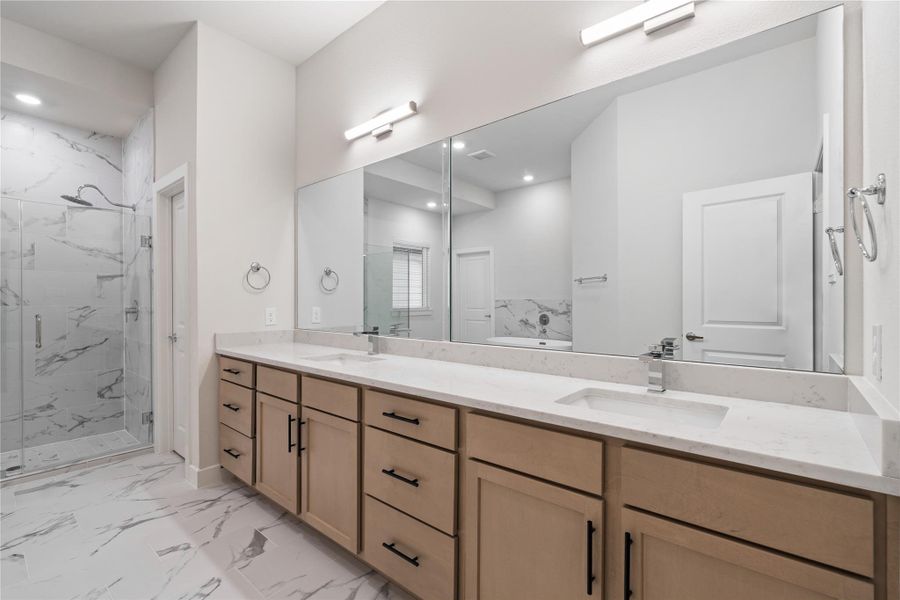 A primary bath of this size is uncommon at this price point, offering a wide double sink vanity with extended counter space that comfortably allows for a makeup station or added storage.