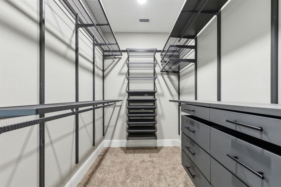 Primary Bedroom walk in closet with organization Primary Bedroom walk in closet with organization