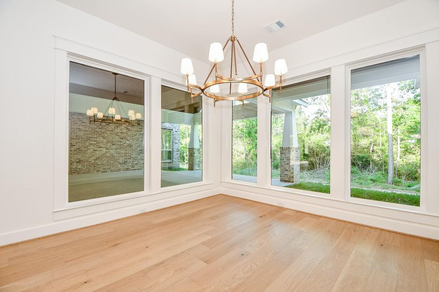 The open dining space offers a modern yet inviting ambiance, framed by large windows that bring the outdoors in. It's perfectly positioned between the kitchen and living room for easy entertaining. The open dining space offers a modern yet inviting ambiance, framed by large windows that bring the outdoors in. It's perfectly positioned between the kitchen and living room for easy entertaining.