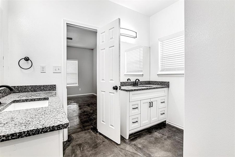 Bathroom with tile patterned floors and vanity