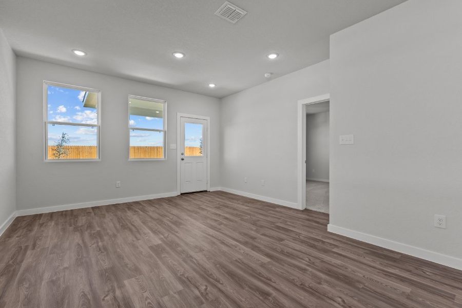 A room with a wood floor and white walls.