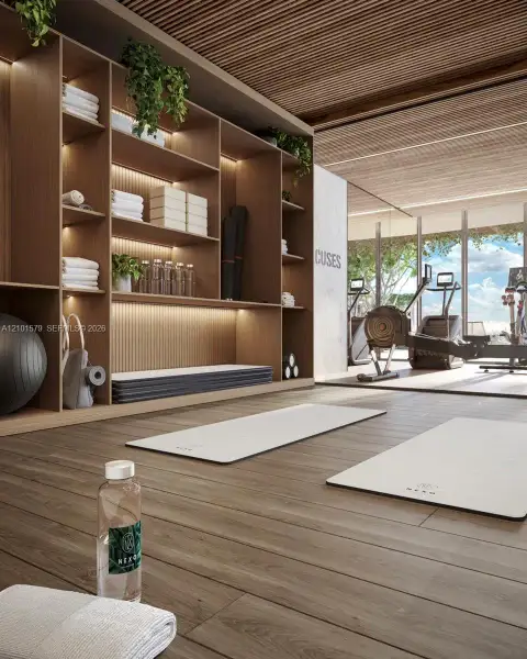 Yoga Studio with Floor-to-ceiling custom wood shelving with integrated LED lighting, linear wood-slat ceiling, wood-finish flooring, and expansive floor-to-ceiling windows. Sauna and showers.