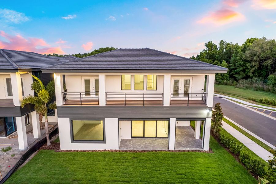 Exterior details and patio area of a home in Hampton Green at Providence, Davenport (Image 15).