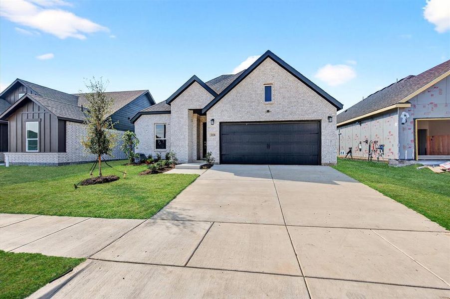 Front exterior of a new home in Hickory Hill, Sherman, TX, highlighting curb appeal (Image 2). Front exterior of a new home in Hickory Hill, Sherman, TX, highlighting curb appeal (Image 2).