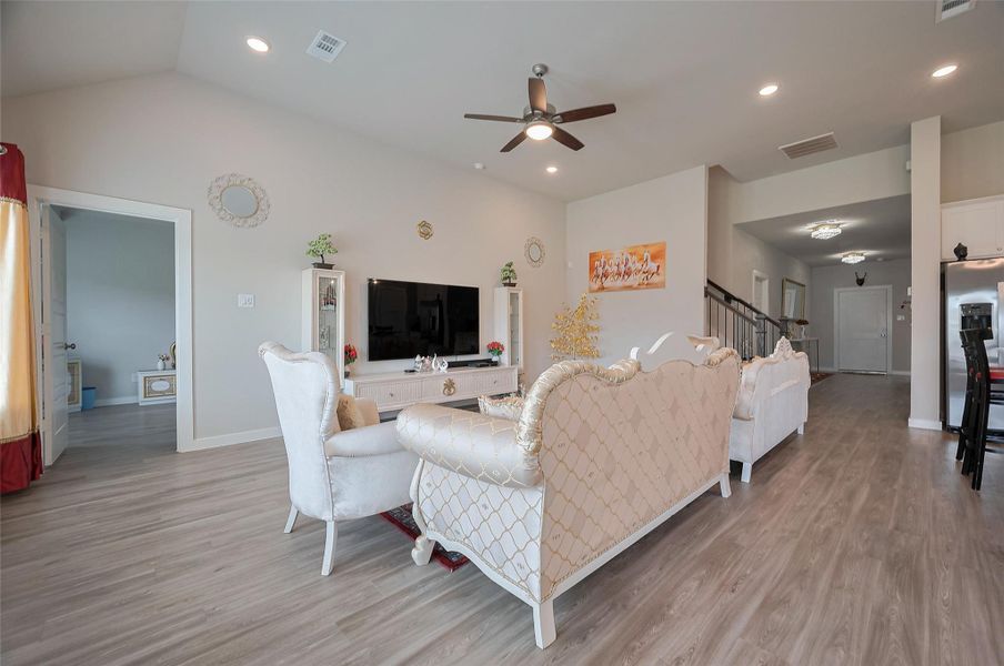 Bright living area with ceiling fan.