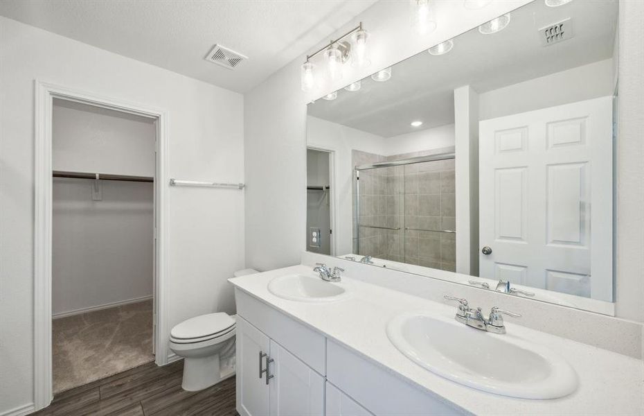 Spacious owner's bath with large shower and dual vanity *real home pictured