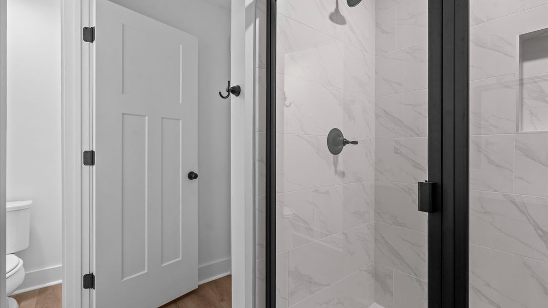 Highly functional and elegant en-suite with dual vanities, tiled walk-in shower, and refined finishes Highly functional and elegant en-suite with dual vanities, tiled walk-in shower, and refined finishes