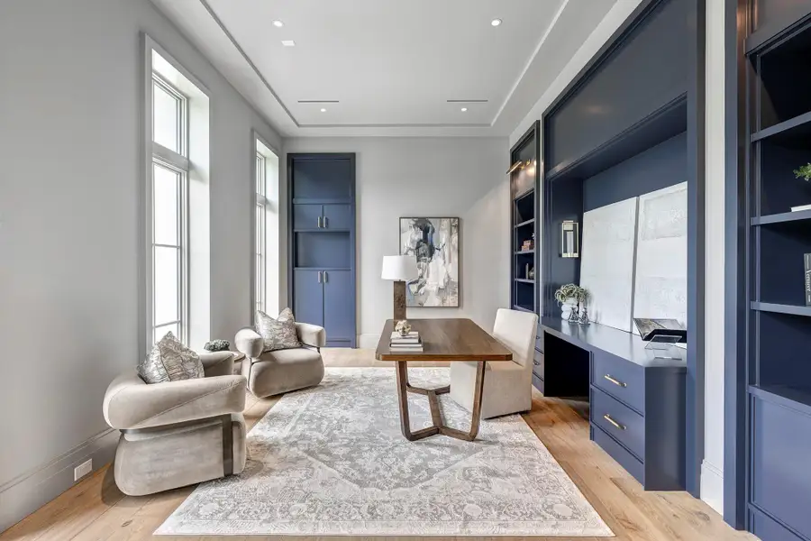 Close the pocket doors and work in this stylish study off the foyer with handsome blue cabinetry.