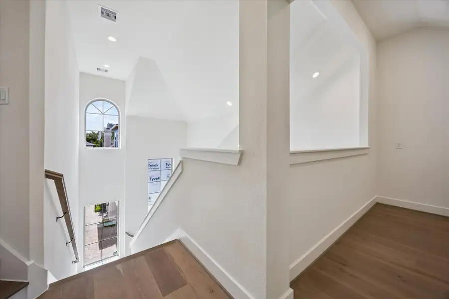 Soaring ceilings and expansive windows flood every level of the home with natural light, creating a bright, airy atmosphere as you ascend through each thoughtfully designed space.