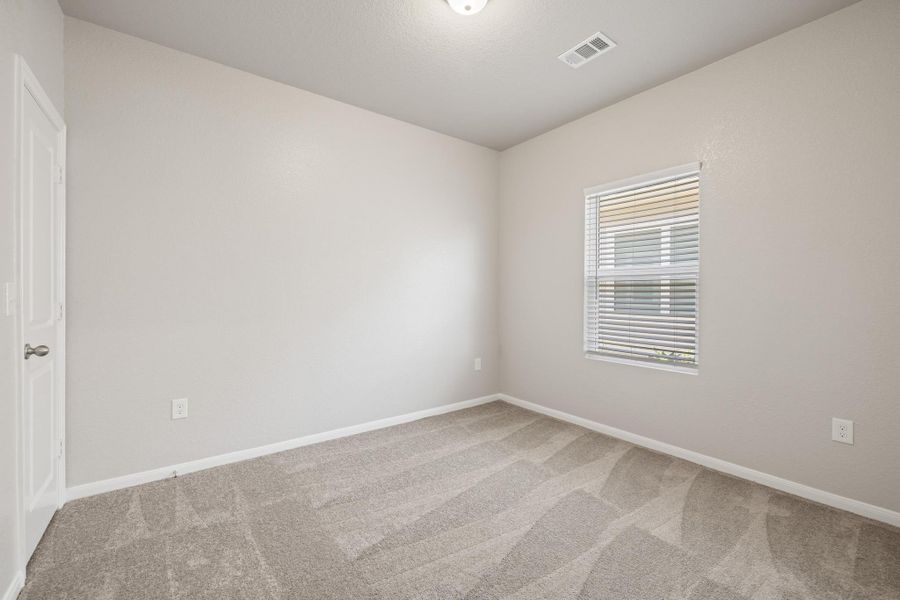 Empty room featuring carpet flooring and baseboards Empty room featuring carpet flooring and baseboards
