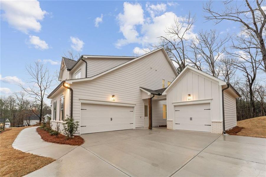 Front exterior of a new home in The Reserve at Knollwood, Canton, GA, highlighting curb appeal (Image 18). Front exterior of a new home in The Reserve at Knollwood, Canton, GA, highlighting curb appeal (Image 18).