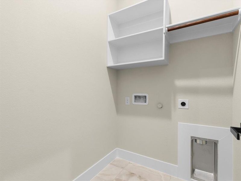 Washroom with hookup for an electric dryer, hookup for a gas dryer, and washer hookup