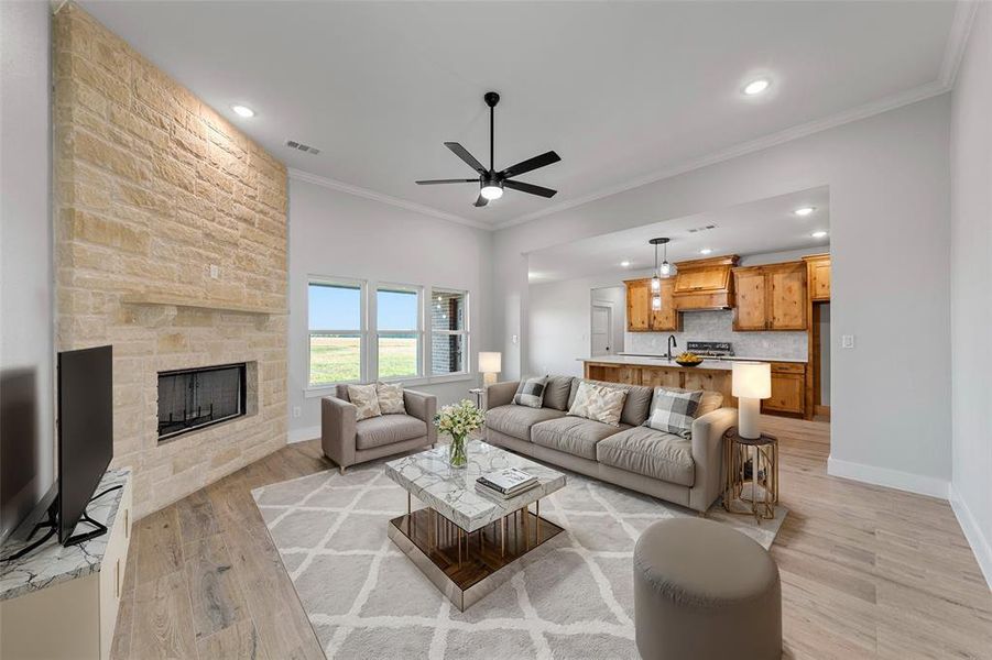 Virtual Staging Living room featuring ceiling fan, light wood-type flooring, a fireplace, and crown molding