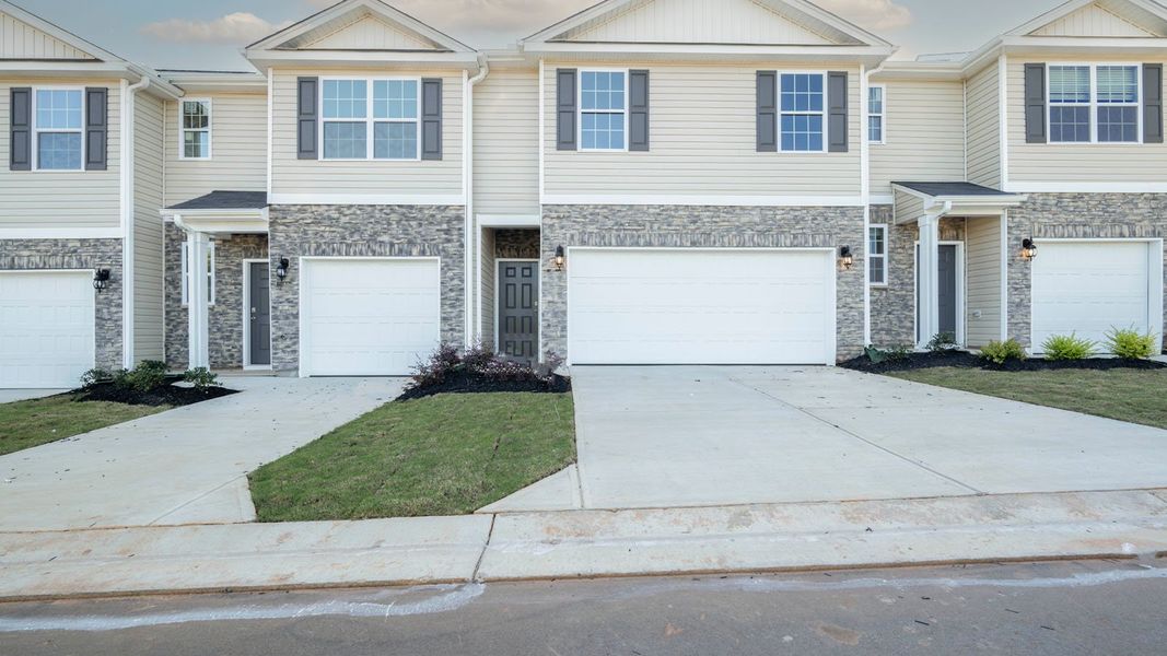 Front exterior of a new home in North Village Townes, Greensboro, NC, highlighting curb appeal (Image 2). Front exterior of a new home in North Village Townes, Greensboro, NC, highlighting curb appeal (Image 2).