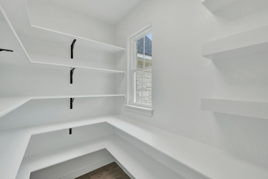 White built-in shelving with black metal supports