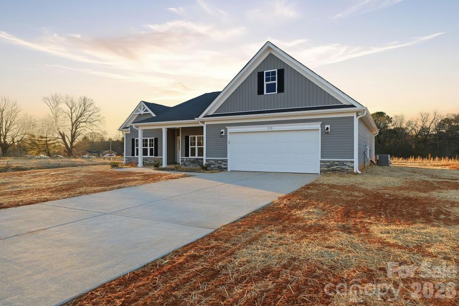 Front exterior of a new home in , Troutman, NC, highlighting curb appeal (Image 16).