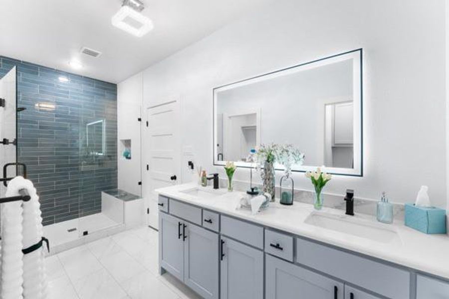 Bathroom with a stall shower, double vanity, and light marble finish flooring Bathroom with a stall shower, double vanity, and light marble finish flooring