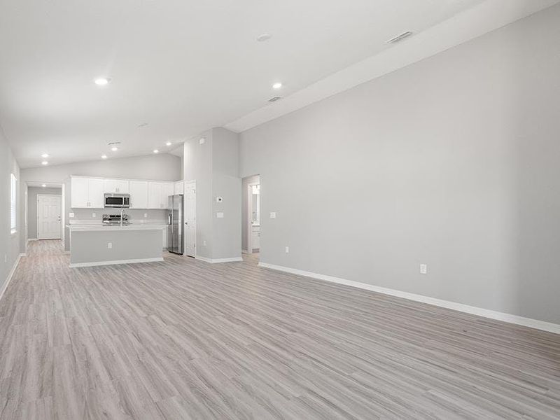 Enjoy a sunny, open-concept living area with volume ceilings - Ashlyn by Highland Homes