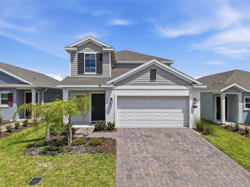 Front exterior of a new home in Wellness Ridge, Clermont, FL, highlighting curb appeal (Image 25).