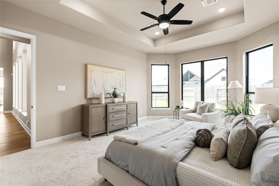 Primary bedroom with plush carpeting, neutral walls, and a stylish ceiling fan, offering a serene and versatile space. *Virtually Staged*