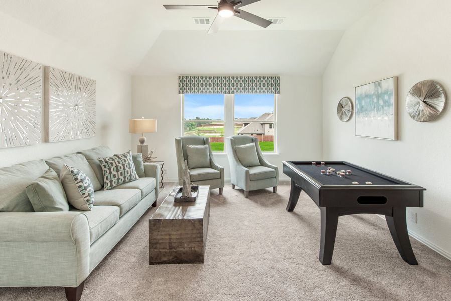 Bonus room with vaulted ceiling, sofa, two accent chairs, and a pool table on carpet Bonus room with vaulted ceiling, sofa, two accent chairs, and a pool table on carpet