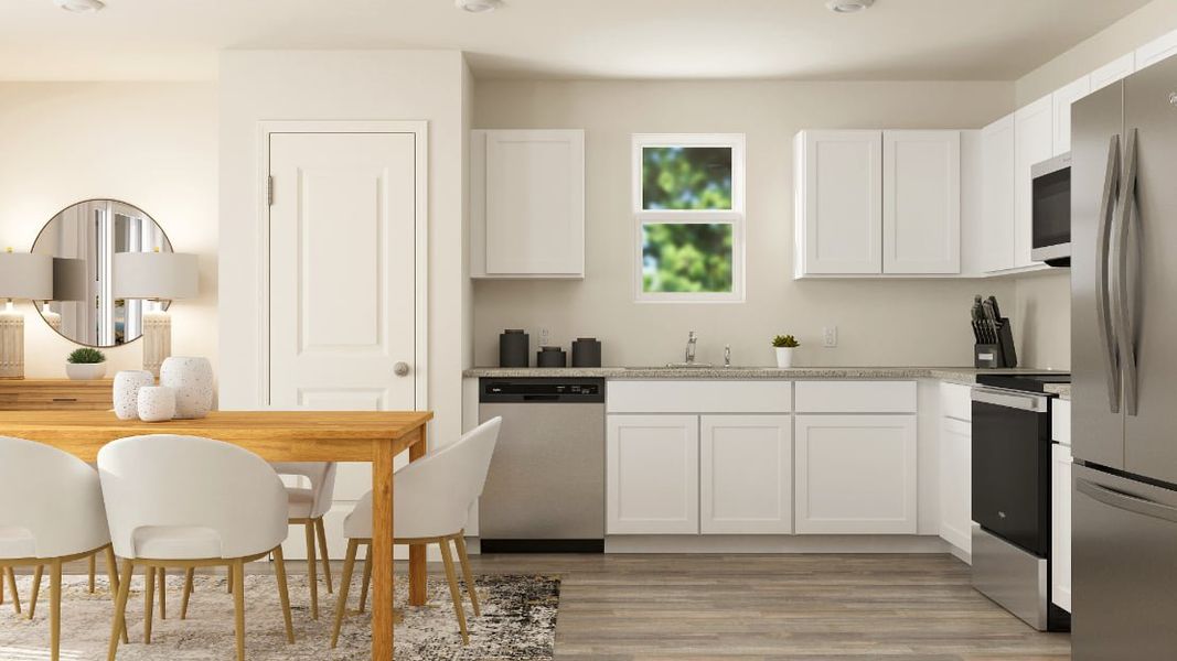 A kitchen with white cabinets.