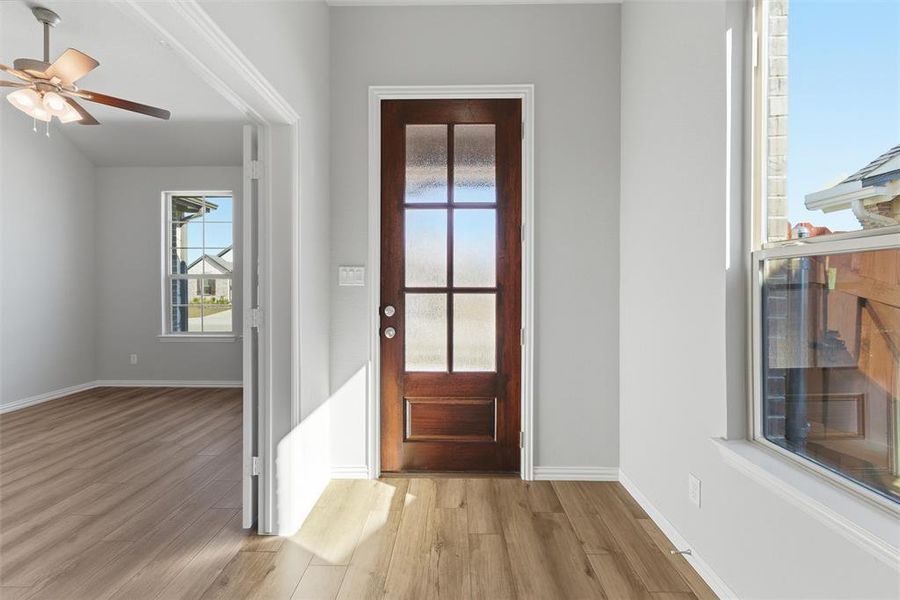 Entryway with light wood-style floors and ceiling fan